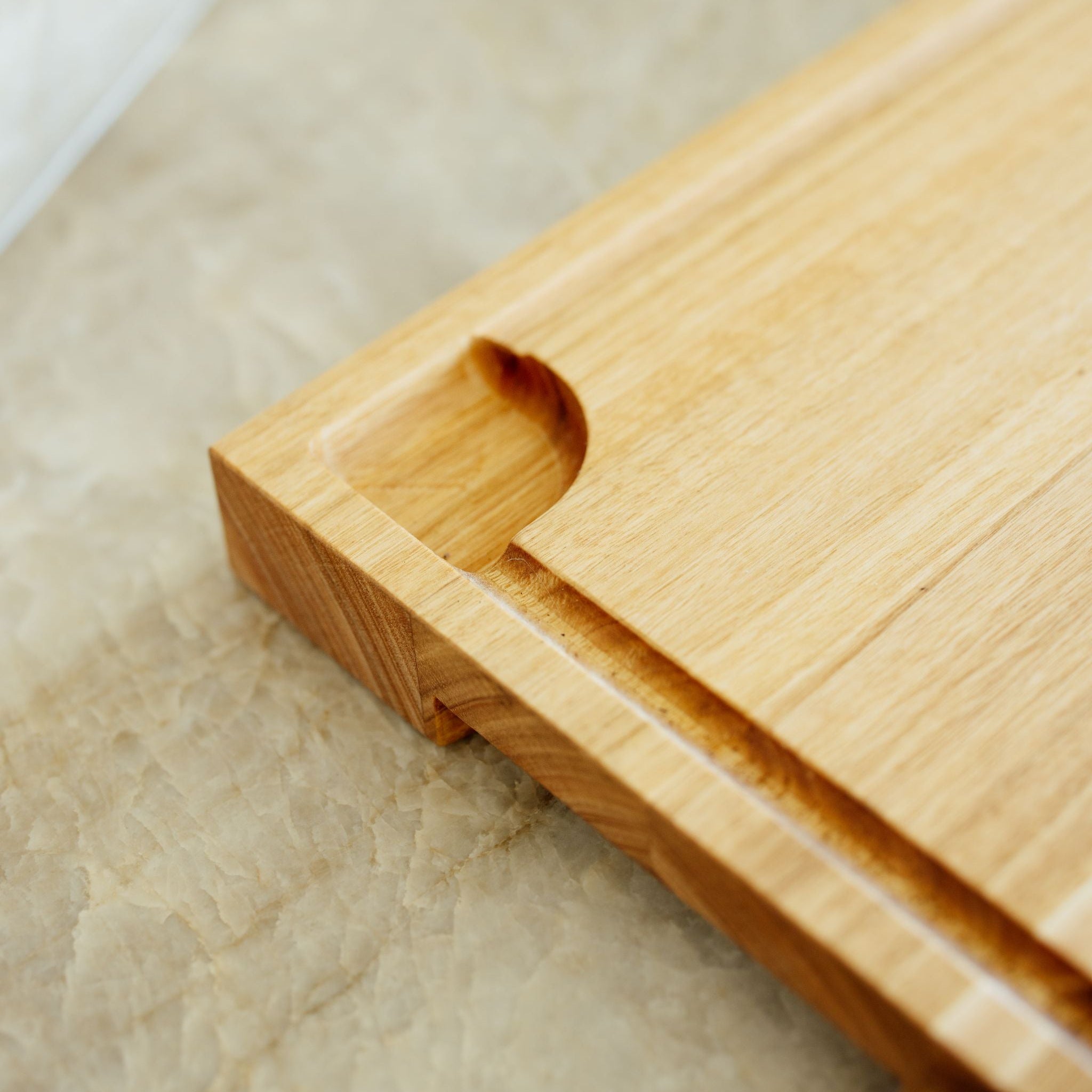 Close-up of a wooden cutting board on a textured surface